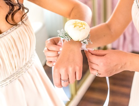 morning routine bride putting on the boutonnieres bridesmaidsの写真素材