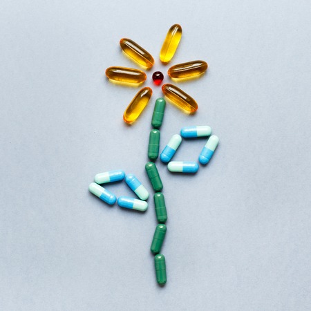 Pills in form of flower on gray background isolated close upの写真素材