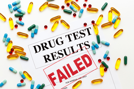 concept drug test results are failed on white background with pillsの写真素材