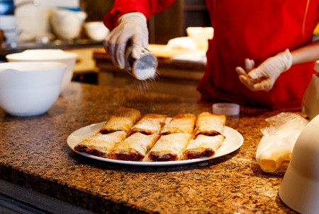 cooking sweet strudel with berries in a cafe