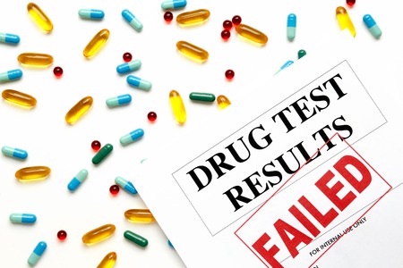 concept drug test results are failed on white background with pills