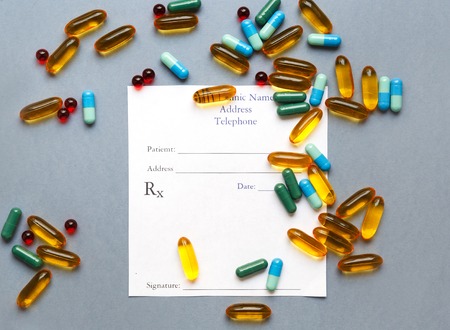 blank medical prescription and pills on gray background isolatedの写真素材