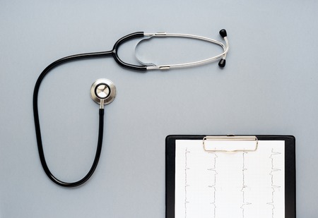 empty doctor workplace with a stethoscope view from above isolatedの写真素材