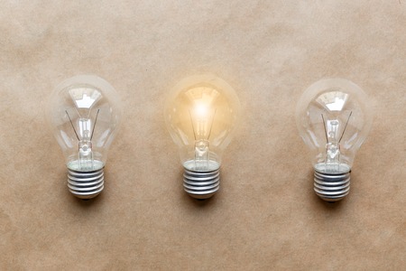 three glass bulbs for lamps - idea concept on paper backgroundの写真素材