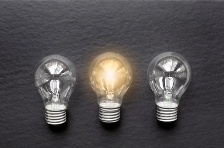 three glass bulbs for lamps - idea concept on black background