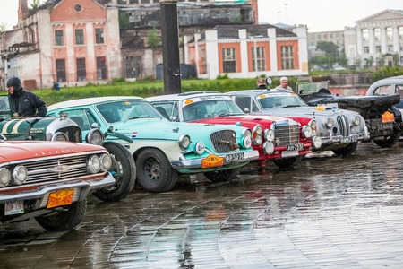 Omsk, Russia - June 11, 2013: stage of Rally Peking-Paris by retro cars in Siberia, cars standing under rainのeditorial素材