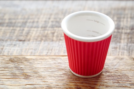 empty coffee cup on a wooden table close upの写真素材