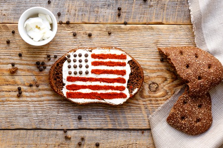 Patriot breakfast - sandwich with image of american flag on wooden table. Top view.の写真素材