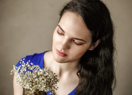 portrait of young girl with wavy long hair with flowersの写真素材