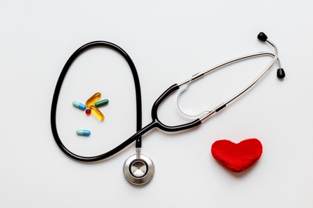 stethoscope on a white background with plush red heart top viewの写真素材