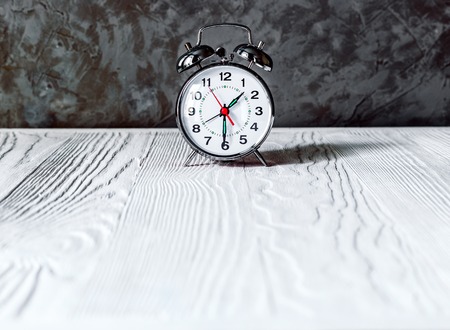 alarm clock on an empty locker on white background