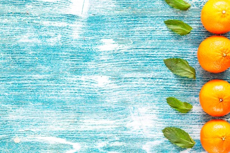 oranges on a blue wooden table top viewの写真素材