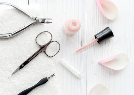 open bottle of nail polish with manicure set on wooden background top viewの写真素材