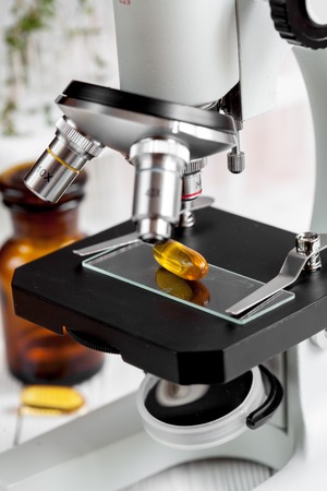 concept - check dietary supplements on microscope slide in laboratory no oneの写真素材