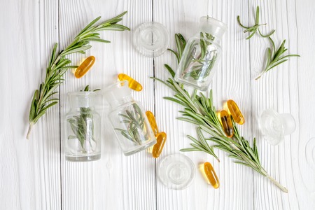 natural medicine - herbs on wooden table top view on white backgroundの写真素材