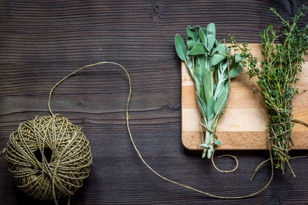 harvesting herbs - thyme, sage for winter top view on wooden backgroundの写真素材