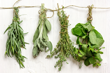 bundles of fresh herbs on wooden background top viewの写真素材