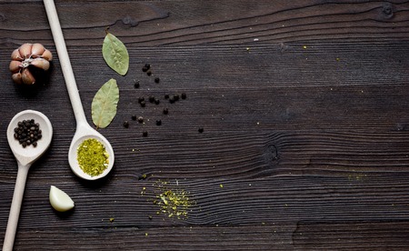 spices in spoon on dark wooden table top viewの写真素材