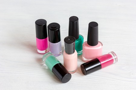 group of nail polish on wooden background.