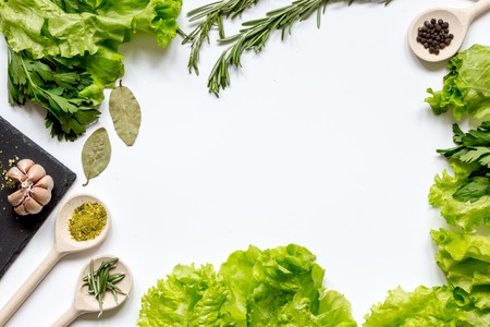 spices for cooking and fresh herbs, salad on white table top viewの写真素材