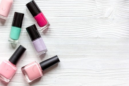 group of nail polish on wooden background top view.の写真素材