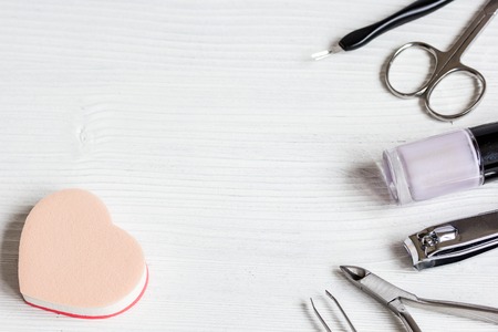 nail polish, cuticle oil and manicure set on wooden background close upの写真素材