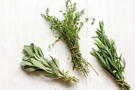 bundles of fresh herbs on wooden background top viewの写真素材