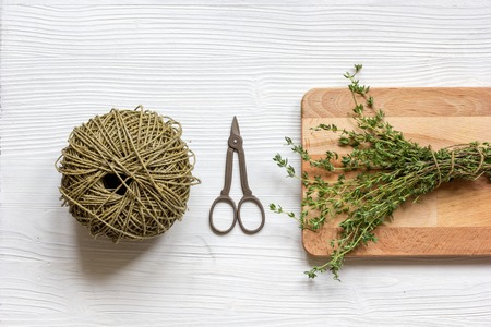 fresh herbs preparation to be dried top view on wooden backgroundの写真素材