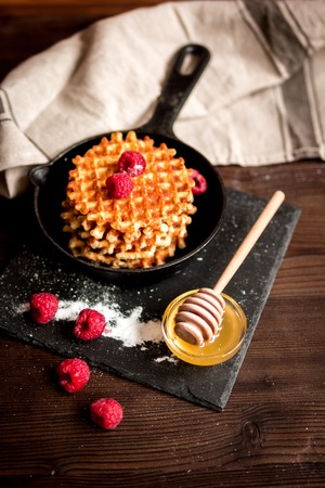 cooking holiday breakfast with wafer on dark wooden background and tableclothの写真素材