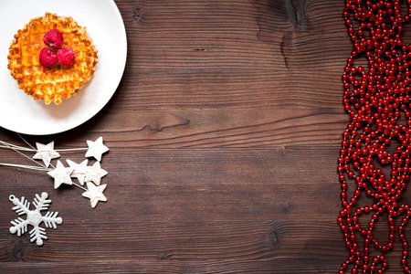Christmas breakfast with waffles and berries top view on wooden backgroundの写真素材