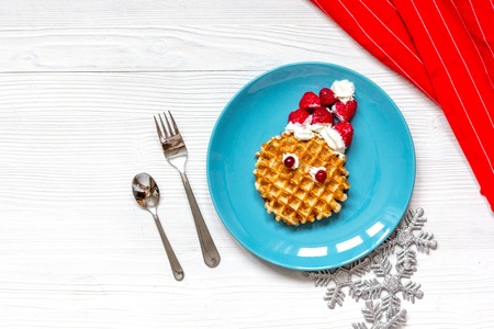 breakfast for child on Christmas with waffle top view on wooden backgroundの写真素材