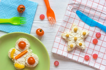 kid breakfast butterfly and star sandwiches top view on wooden backgroundの写真素材