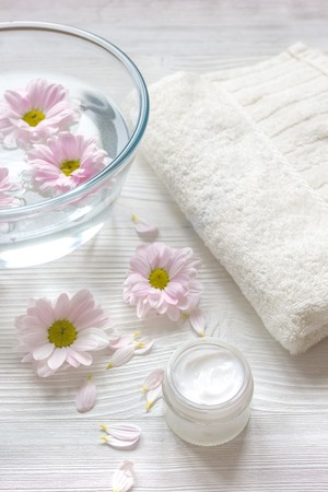 cream and spa on wooden background with flowers close upの写真素材