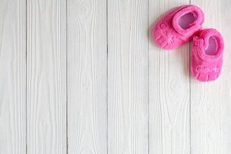 pink booties on wooden background top viewの写真素材