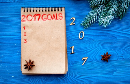 Plans for new year 2017 in blank open notebook on wooden background top viewの写真素材