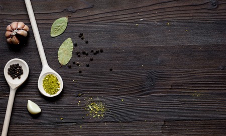 spices in spoon on dark wooden table top viewの写真素材