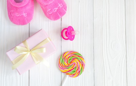 birth of child - lollipop on wooden background top view