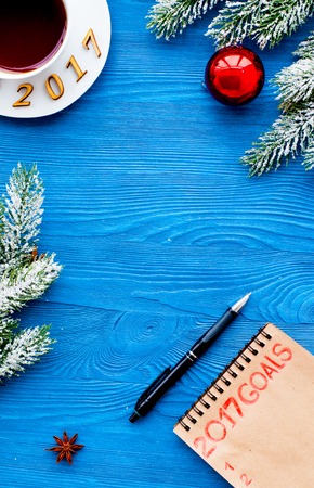 Plans for new year 2017 in blank open notebook on wooden background top viewの写真素材
