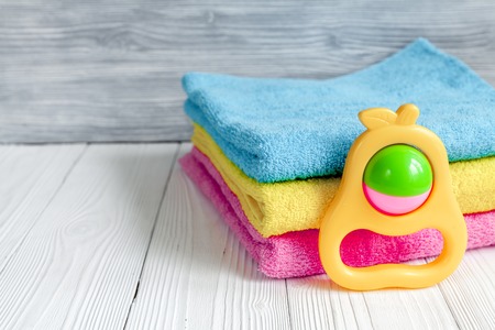 children's clothes and baby booties on wooden background top viewの写真素材