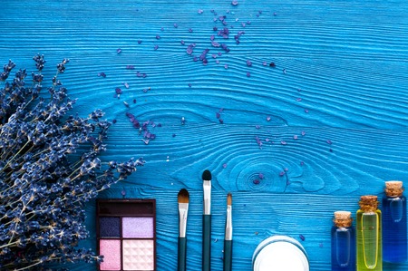 decorative cosmetics with lavender on dark wooden background top viewの写真素材