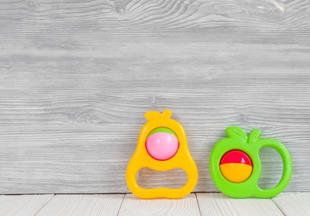 baby rattle on wooden background top view