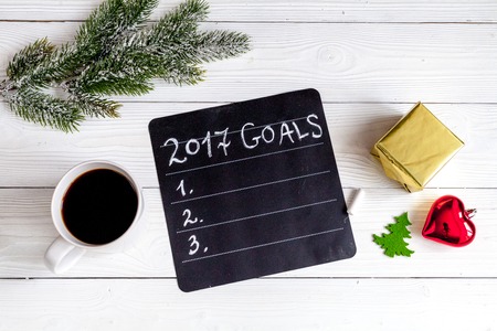 notebook and goals for new 2017 year on dark wooden background top viewの写真素材