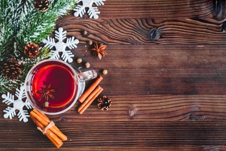 cup with christmas mulled wine on dark wooden background top view.の写真素材