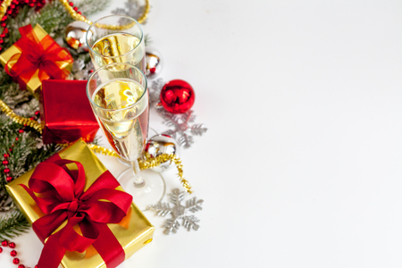 glasses of champagne and Christmas ornaments top view on white background.の写真素材