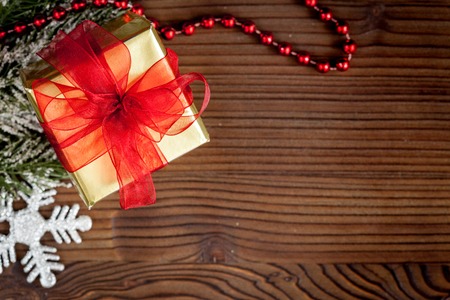 packaging christmas gifts in boxes on wooden background top view.