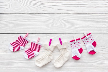 baby socks on rope at wooden background top viewの写真素材
