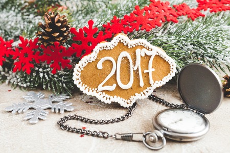 gingerbread and clock on background of christmas toys 2017.