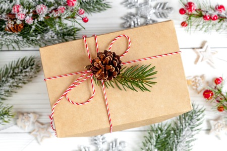 packaging christmas gifts in boxes on wooden background top view.の写真素材