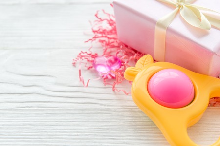 gift for newborn baby on wooden background close up