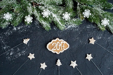 Christmas decorations, spruce branches on dark background top view - 2017